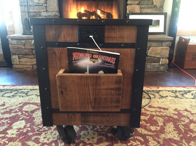 Industrial end table made from wormy chestnut wood (reclaimed from house built in early 1900's).   Custom made steel structure with welded old style rivets, then powder coated.  Three drawers with old tools attached for handles. Integrated outlet with usb charging port.